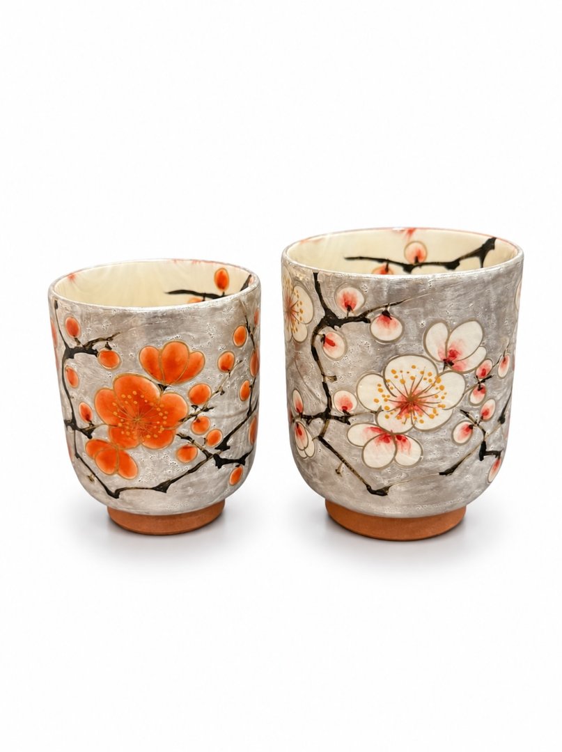 Two teacups painted with plum blossoms
