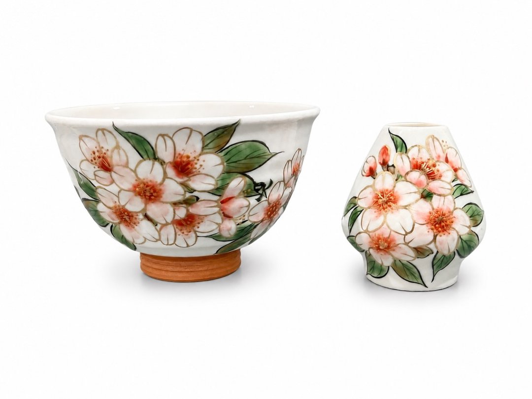 A matcha bowl and chasen rest painted with spring flowers